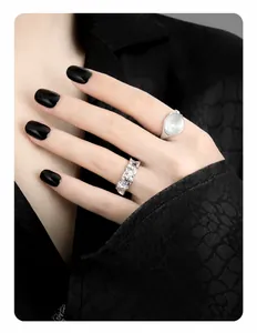 Detailed view of S925 sterling silver rings with irregular lava texture and opal inlay