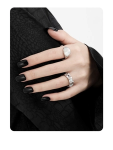 Detail view of S925 silver rings with opal and irregular texture on model's hand