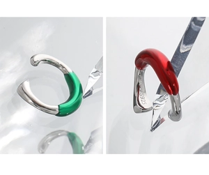 Detail view of S925 sterling silver ear cuffs with green and red enamel accents