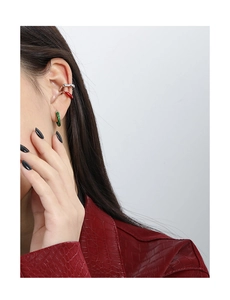 Close-up of minimalist S925 silver twist ear cuffs set in red, green and silver finish