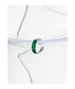 Detail of silver S925 ear cuff with twisted texture and dark green enamel finish