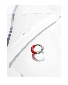 Minimalist silver ear cuff with red enamel coating detail on textured twisted metal