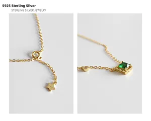 Detail van S925 zilveren stempel en smaragd zirkoon hanger aan gouden ketting