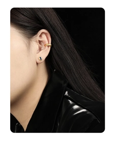 Detailed view of S925 silver ear cuff and earring with blue zircon on model ear