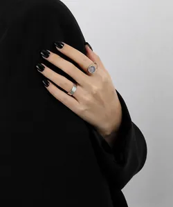 Close-up of minimalist S925 sterling silver wide band and moonstone ring on model