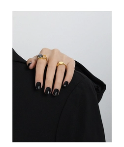 Close-up of gold geometric S925 silver rings with oval labradorite on model hand