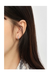 Macro detail of S925 sterling silver hoop earrings with textured chocolate grid pattern
