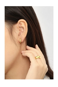 Close-up of minimalist gold plated S925 sterling silver hoop earrings with vertical texture