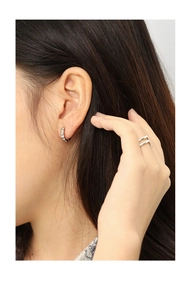 Detail of minimalist silver-plated hoop earrings with micro-inlaid zircons and a double-layer ring