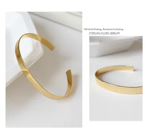 Macro shot of minimalist 18K gold plated S925 sterling silver cuff with mirror finish
