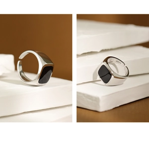 Macro shot of S925 sterling silver ring featuring a black rectangular enamel top and engraving