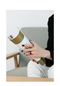 Detail of minimalist S925 sterling silver rings with black enamel on a magazine
