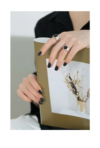 Detailed close-up of geometric S925 silver rings with black enamel square and hexagon shapes