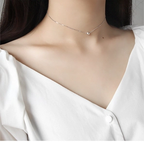 Close-up of minimalist S925 sterling silver choker with a round bead on thin box chain