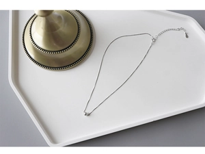 Detail view of a S925 sterling silver ball necklace with lobster clasp and extender chain