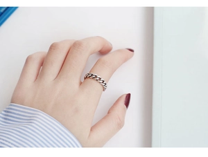 Close-up of vintage S925 sterling silver chain ring with distressed texture finish