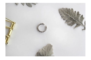 Detail of vintage S925 sterling silver chain ring with textured twist rope design