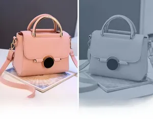 Detailed view of pink leather crossbody bag with gold curved handle and magnetic lock