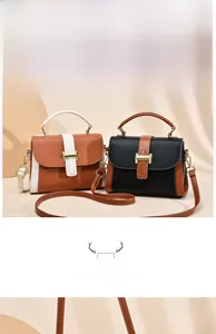 Detail of color-block handbags with textured leather and metal H-shaped clasp buckle