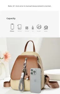 Vue détaillée d'un petit sac à dos bicolore montrant le rangement pour téléphone et accessoires
