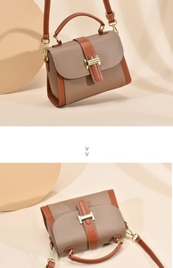 Detail of grey-brown and orange leather handbag with gold metal clasp and top handle