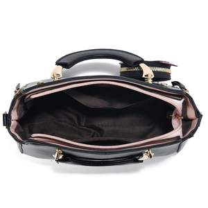 Top view of black handbag with pink lining, showing main compartment and zip pocket
