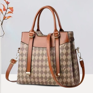 Elegant beige and brown monogram tote bag with leather handles and gold-tone hardware