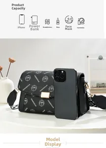 Macro view of black shoulder bag with gold hardware and wide geometric strap detailing