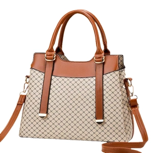 Brown leather and beige canvas handbag with geometric print and adjustable shoulder strap