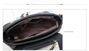 Interior detail of black pebble leather crossbody bag with multiple compartments
