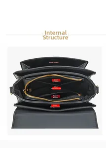 Detailed interior view of a black leather handbag featuring organized compartments and gold zippers