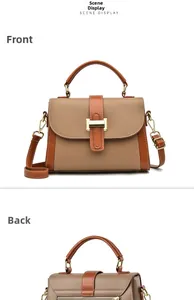 Close-up of vintage brown leather square bag with golden H buckle and fine lychee texture