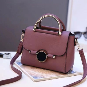 Mauve lychee texture crossbody bag with gold ring handle and round metal buckle