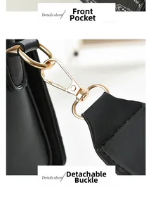 Close-up of black handbag with golden hardware, front pocket and jacquard strap