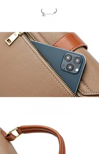 Detail of brown lychee leather handbag featuring back anti-theft zipper pocket and handle