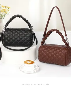 Quilted cylindrical handbags in black and brown with ruched handles and metal hardware