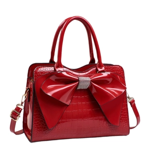 Red crocodile pattern handbag with large rhinestone bow and adjustable shoulder strap