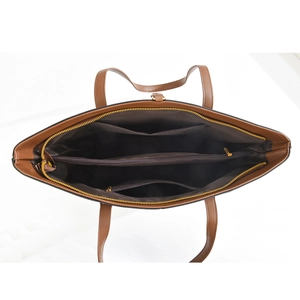 Detailed top view of the tote bag interior with multiple compartments and gold zippers