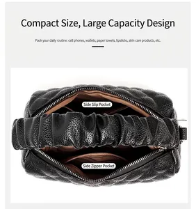 Detail view of black pleated handbag interior with side pockets and zipper compartment