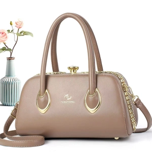 Detail of light brown doctor style handbag with lychee texture and gold metal clasp
