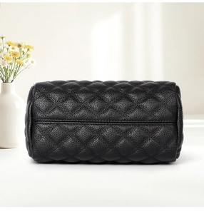 Macro detail of high-quality black quilted leather bag with fine stitching texture