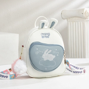 Mini crossbody bag with 3D bunny ears and white-blue patchwork on a white pedestal