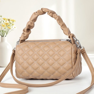 Quilted crossbody bag in apricot with cloud handle and long shoulder strap