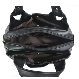 Detailed interior view of a black leather handbag featuring multiple practical compartments
