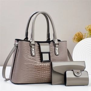 Three-piece women's handbag set with grey lizard embossed leather and glossy finish