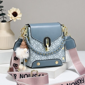 Gray-blue square crossbody bag with monogram pattern and wide colorful shoulder strap