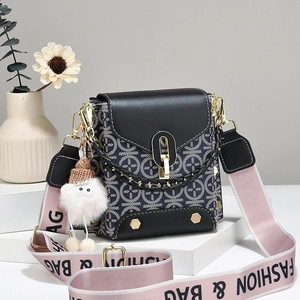 Navy blue monogram crossbody bag with gold hardware and pink fashion webbed strap