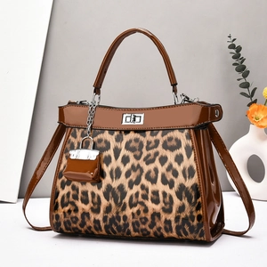 Brown leopard print glossy tote bag with silver twist lock and mini charm accessory