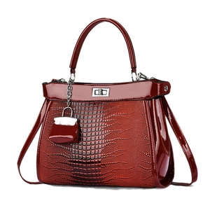 Deep burgundy crocodile pattern faux leather handbag with silver lock and mini bag charm