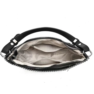Internal view showing herringbone lining and compartments of black leather handbag